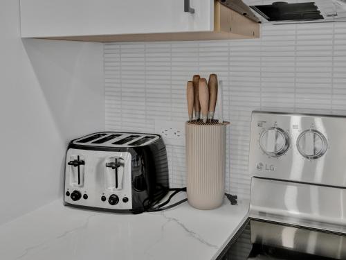 a kitchen counter with a knife block and a toaster at Luxe Retreat in the Heart of Dallas l Pet-Friendly in Dallas