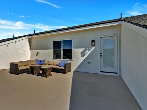 a patio of a house with a couch and a table at Luxe Retreat in the Heart of Dallas l Pet-Friendly in Dallas