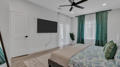 a bedroom with a bed and a flat screen tv at Luxe Retreat in the Heart of Dallas l Pet-Friendly in Dallas