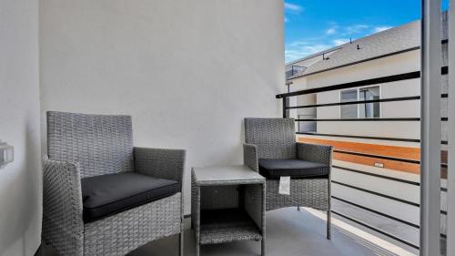 two chairs and a table on a balcony at Luxe Retreat in the Heart of Dallas l Pet-Friendly in Dallas