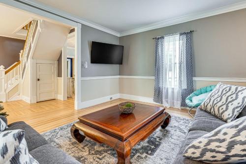 a living room with a couch and a coffee table at Ski, Hike and Fish Modern Rutland Home in Rutland