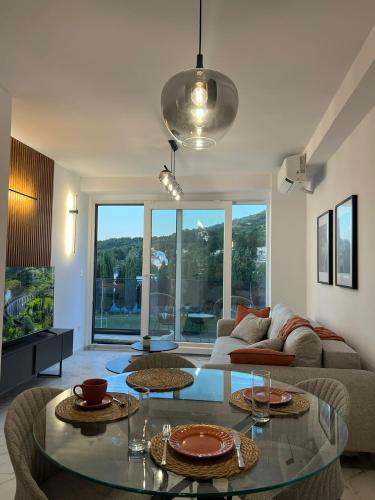 a living room with a table and a couch at Yves Lake Front Apartments in Ohrid