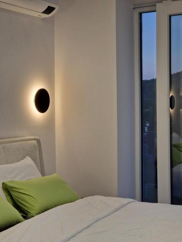 a bedroom with a bed and a window at Yves Lake Front Apartments in Ohrid