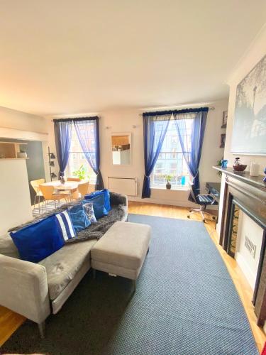 a living room with a couch and a fireplace at Beautiful Apartment in Temple Bar in Dublin
