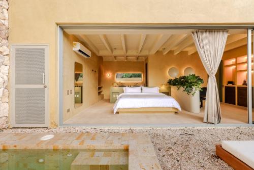 a bedroom with a bed and a swimming pool at Arde La Selva in Santa Fe de Antioquia