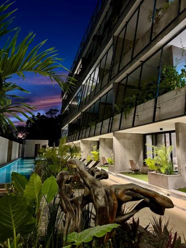 a bronze statue in front of a building at ZEL-VA Tulum Apartments in Tulum