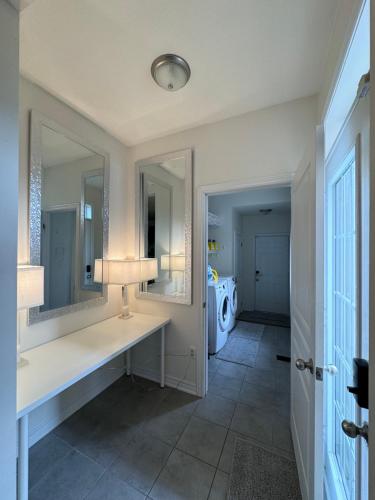 a bathroom with a white counter and two mirrors at 9 Queen Beds, 18 Guests-Kleinburg Luxe Crown Town Residence in Vaughan