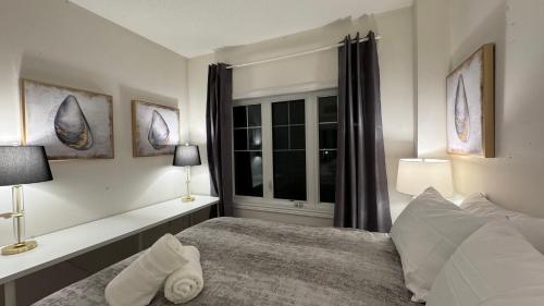 a bedroom with a bed with two lamps and a window at 9 Queen Beds, 18 Guests-Kleinburg Luxe Crown Town Residence in Vaughan