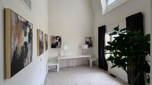 a white room with a desk and pictures on the wall at 9 Queen Beds, 18 Guests-Kleinburg Luxe Crown Town Residence in Vaughan