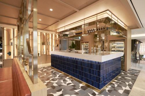 a bar in a restaurant with a blue tile floor at voco Seoul Myeongdong by IHG in Seoul