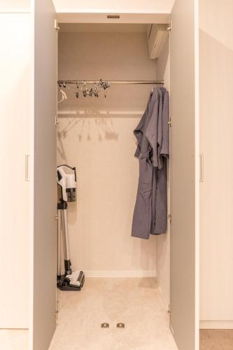 a walk in closet with a door open at coconehouse namba family type in Osaka