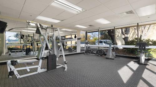 a fitness room with a gym with tread machines at Howard Johnson by Wyndham Sacramento Downtown in Sacramento