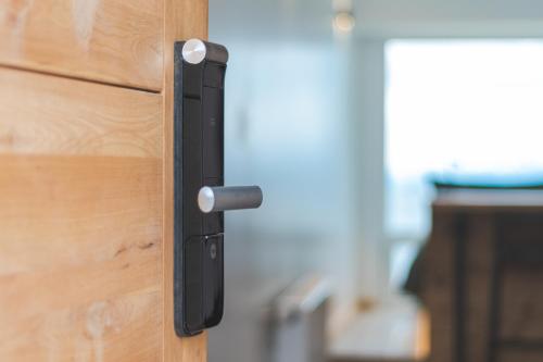 a black door handle on a wooden door at Loft By Toore Patagonia in Puerto Natales