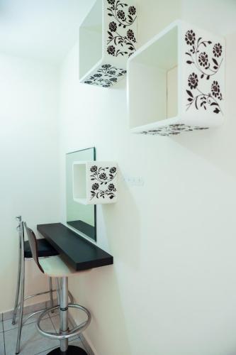 a desk with a chair and a mirror on a wall at Mackenzie Apartment 101 in Larnaka