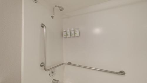 a shower in a bathroom with a towel rack at Howard Johnson by Wyndham Sacramento Downtown in Sacramento