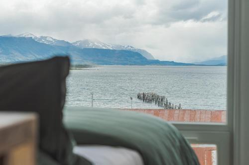 a view of a large body of water from a window at Loft By Toore Patagonia in Puerto Natales