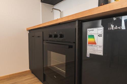 a black microwave oven sitting next to a counter at Loft By Toore Patagonia in Puerto Natales