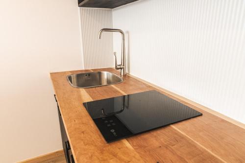 a kitchen with a sink and a counter top at Loft By Toore Patagonia in Puerto Natales