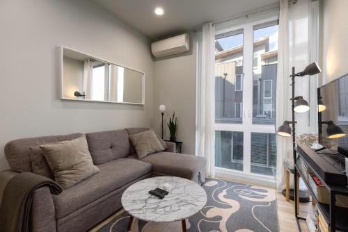 a living room with a couch and a table at West Seattle - Mins to Downtown! in Seattle