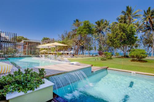a swimming pool with a fountain in a resort at Club Wyndham Mission Beach in Mission Beach