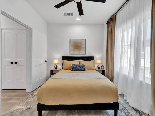 a bedroom with a bed and a ceiling fan at Sophisticated Dallas Retreat l Prime Location! in Dallas