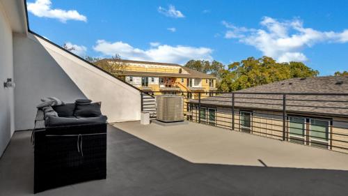 a balcony with a chair and stairs on a building at Sophisticated Dallas Retreat l Prime Location! in Dallas