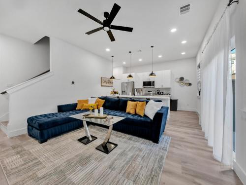 a living room with a blue couch and a table at Sophisticated Dallas Retreat l Prime Location! in Dallas