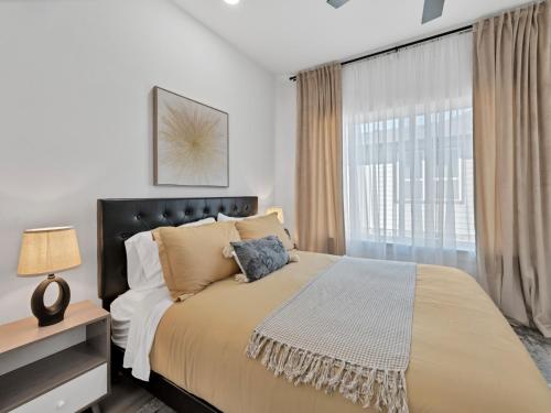 a bedroom with a large bed and a window at Sophisticated Dallas Retreat l Prime Location! in Dallas