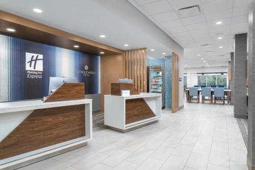 a lobby of a store with tables and chairs at Holiday Inn Express Chattanooga - Hamilton Place in Chattanooga