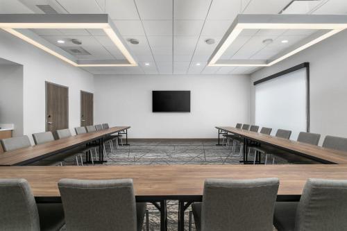 a conference room with tables and chairs and a tv at Holiday Inn Express Chattanooga - Hamilton Place in Chattanooga