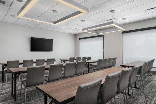 a conference room with tables and chairs and a tv at Holiday Inn Express Chattanooga - Hamilton Place in Chattanooga