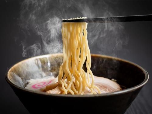 a bowl filled with noodles with a chopstick at TAOYA Shirahama Senjyo in Shirahama