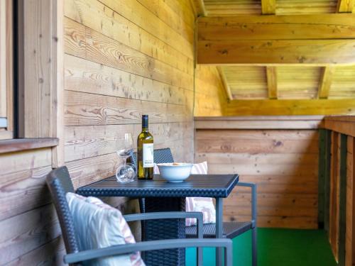 an outdoor table with a bottle of wine and two chairs at Jaggi in Hopfgarten im Brixental