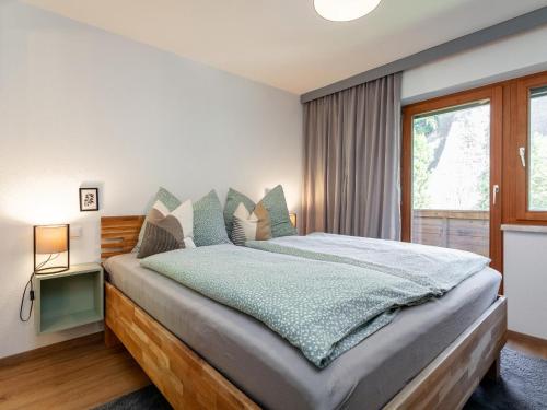 a bedroom with a large bed and a window at Jaggi in Hopfgarten im Brixental