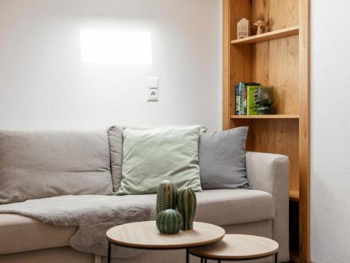 a living room with a couch and two tables with a cactus at Jaggi in Hopfgarten im Brixental