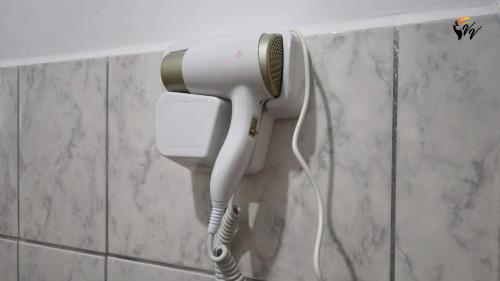 a hair dryer is hanging on a wall at Pousada Fazenda Vale Verde in Sete Barras
