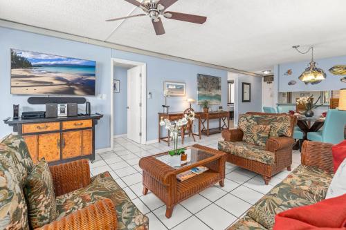 a living room with a couch and chairs and a table at Rear Ocean View 2 Bedroom Single Level Condo at Kamaole Sands 9-305 in Wailea