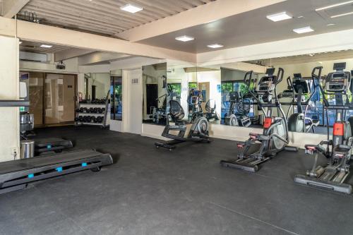 a gym with several treadmills and elliptical machines at Rear Ocean View 2 Bedroom Single Level Condo at Kamaole Sands 9-305 in Wailea