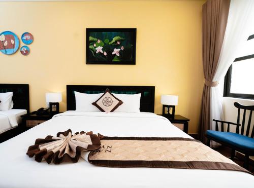 Postel nebo postele na pokoji v ubytování Nature Resort Hoi An By K D H