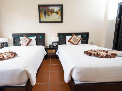 Postel nebo postele na pokoji v ubytování Nature Resort Hoi An By K D H
