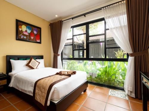 Postel nebo postele na pokoji v ubytování Nature Resort Hoi An By K D H
