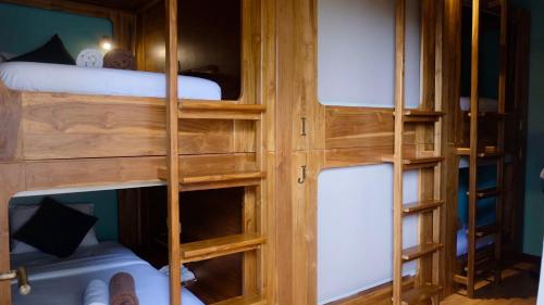 a room with two bunk beds in a room at PORTER HOTEL - Surf & Yoga Retreat in Kuta Lombok