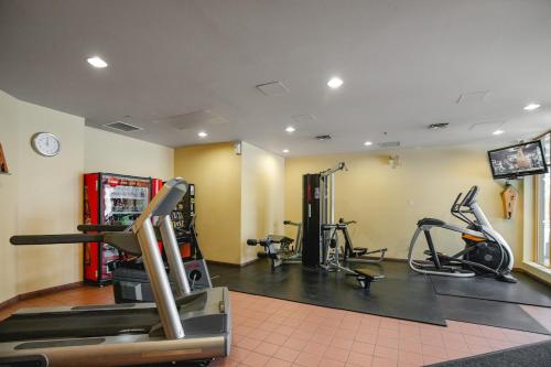 a gym with treadmills and exercise bikes in a room at KING Bed STUDIO in the Village in Whistler