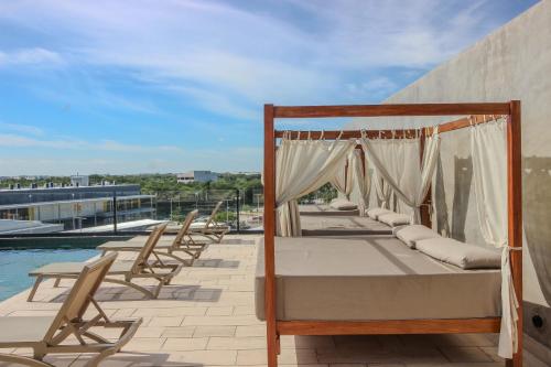 a bed on a patio next to a pool at Luxury Studio with Rooftop Pool and Gym in Top Location in Tulum