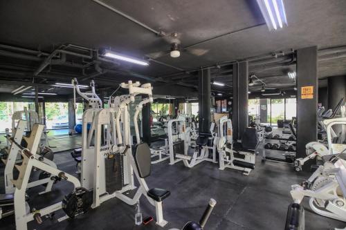 a gym with a lot of tread machines at Luxury Studio with Rooftop Pool and Gym in Top Location in Tulum