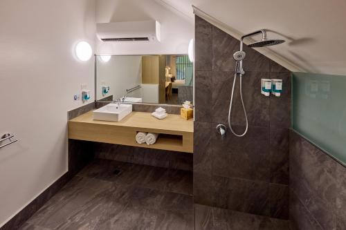 a bathroom with a shower and a sink at Club Wyndham Mission Beach in Mission Beach