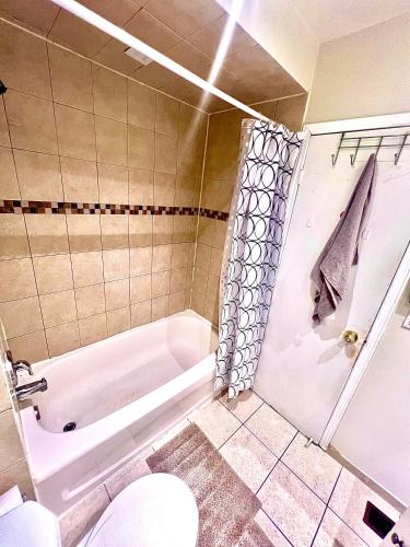a bathroom with a tub and a toilet and a sink at Private Room Near Airport D2 in Brampton