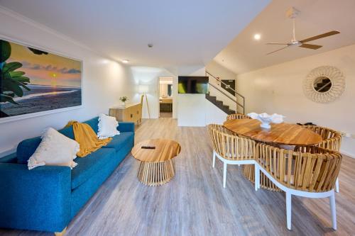a living room with a blue couch and a table at Club Wyndham Mission Beach in Mission Beach