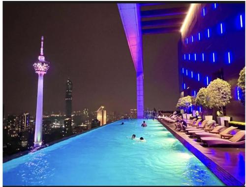 a swimming pool on top of a building with a city at KLCC Sky Villa Suites Platinum in Kuala Lumpur
