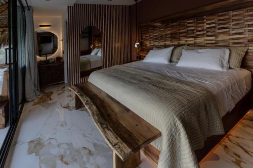 a bedroom with a bed with a smashed floor at Lu Vee Oasis in Puerto Escondido